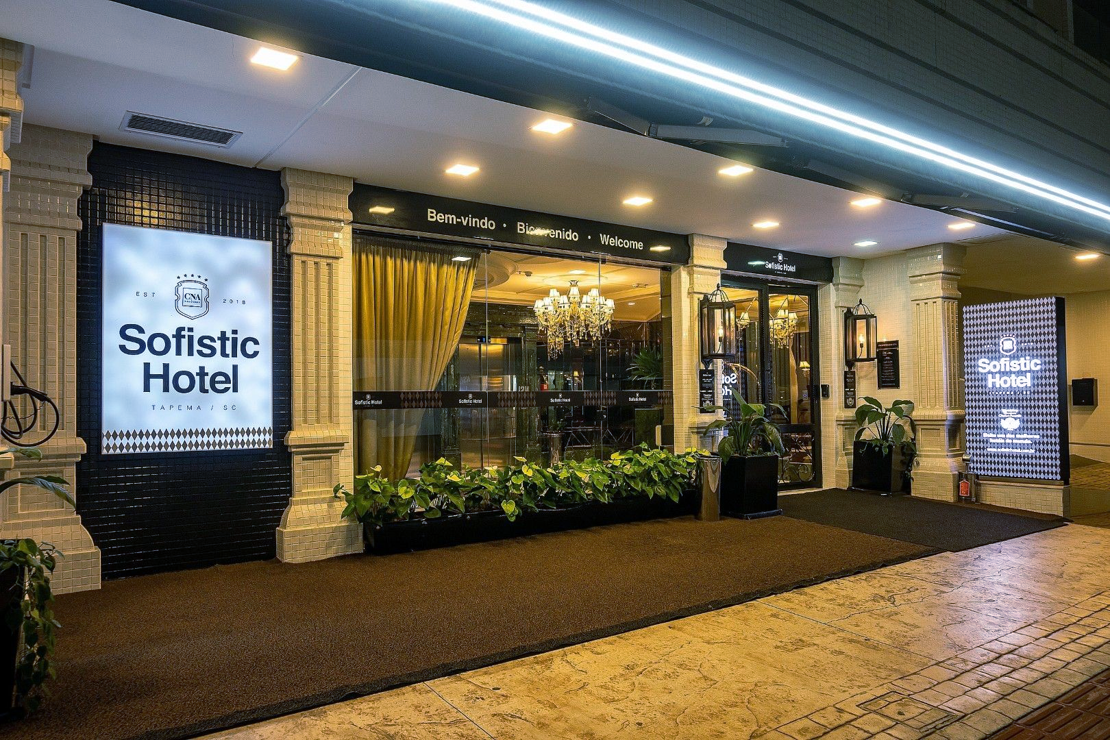 Um grande edifício com muitas janelas e portas fica na beira da estrada.