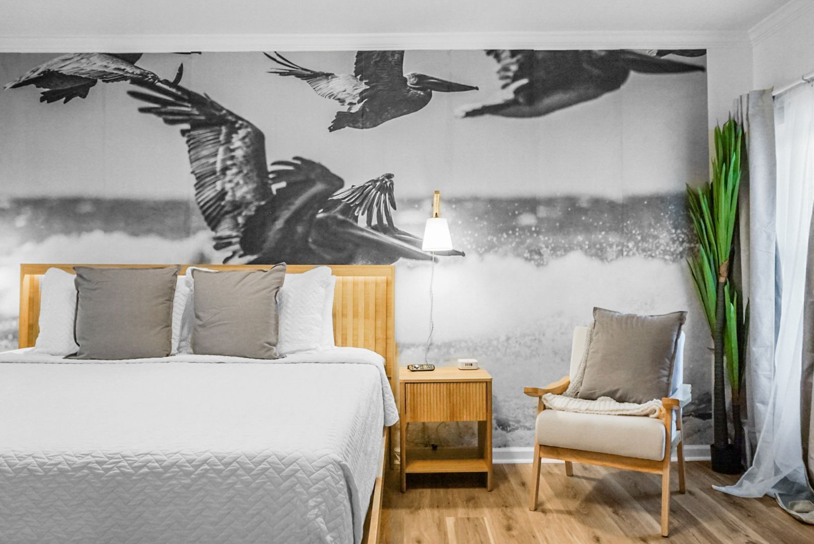 There is a painting on the wall above the bed in the bedroom.