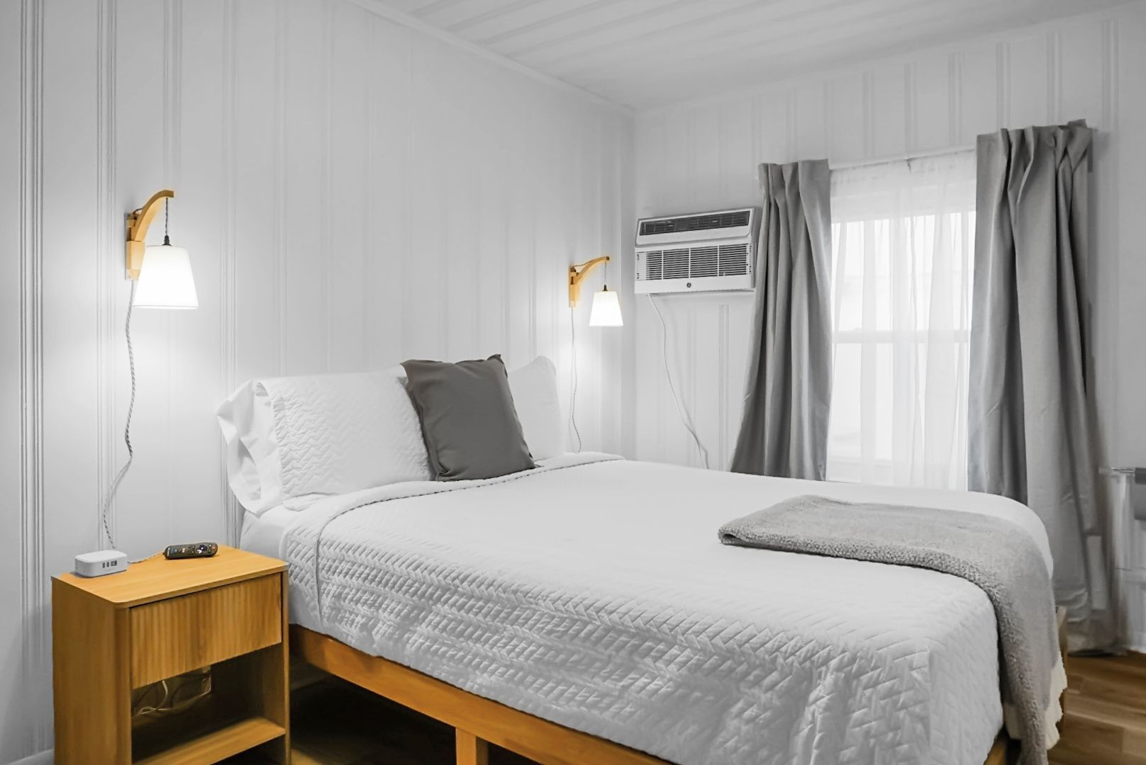 There are two paintings on the wall above the bed.