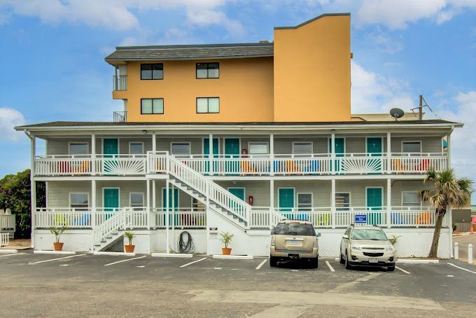 A large yellow building with cars parked in front of it