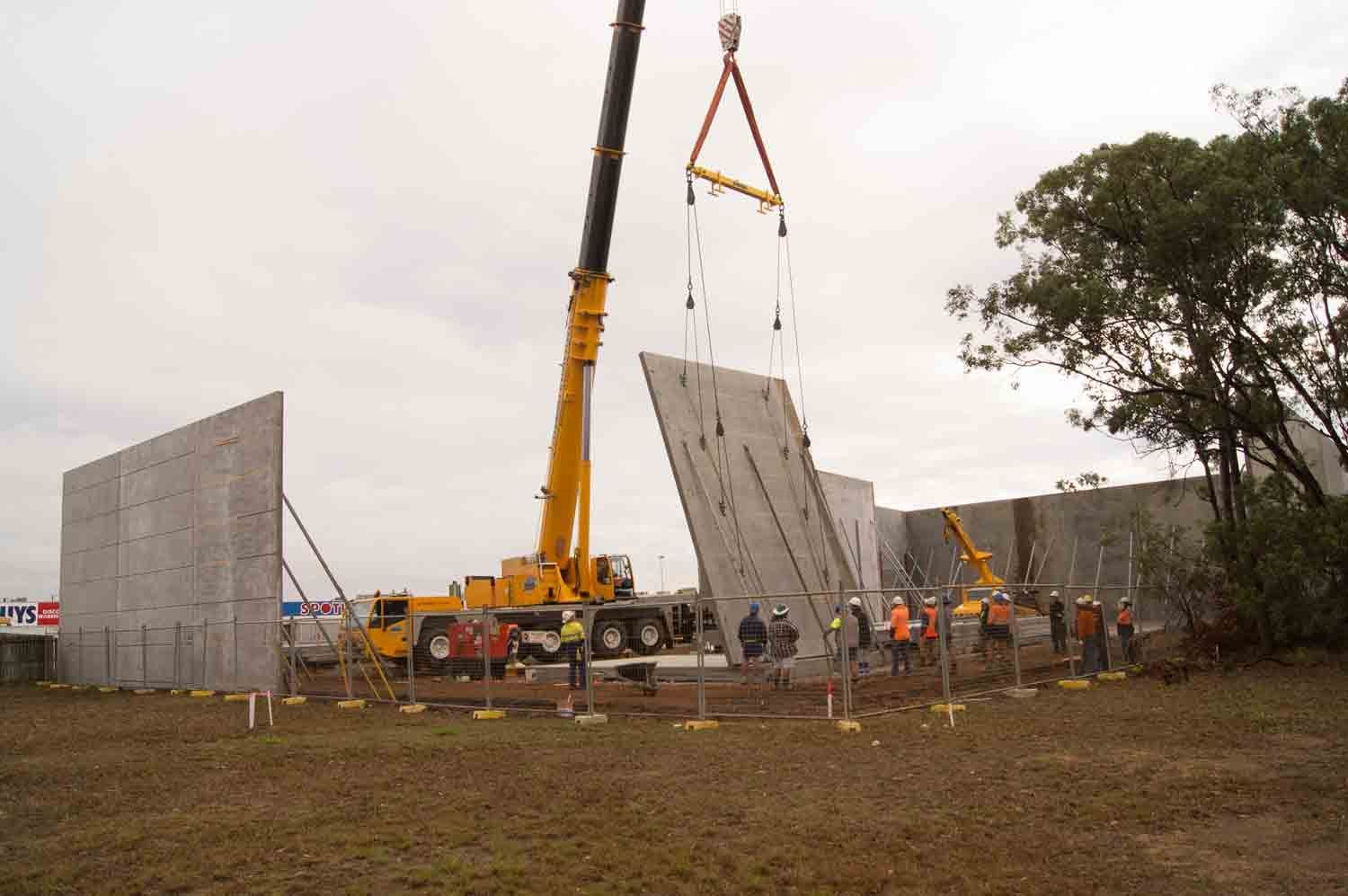 Crane Lifting A Precast Concrete Wall Panel — Wieland Concreting in Rockhampton, QLD