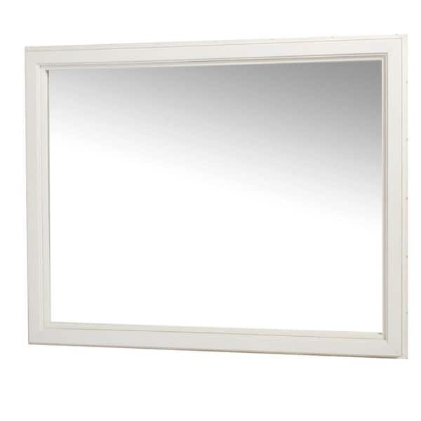 A large white mirror with a white frame on a white background.