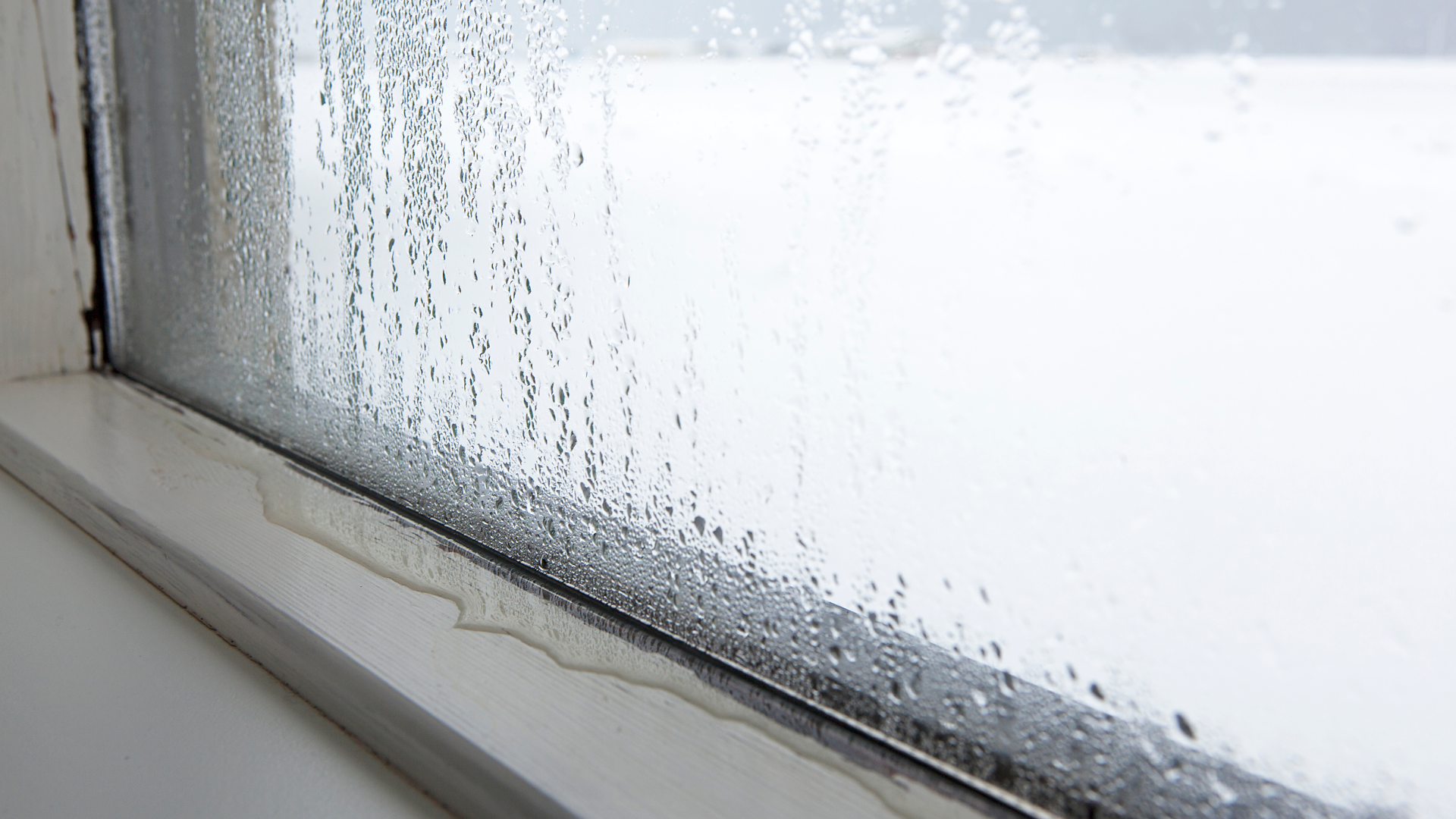 A close up of a window with condensation on it.