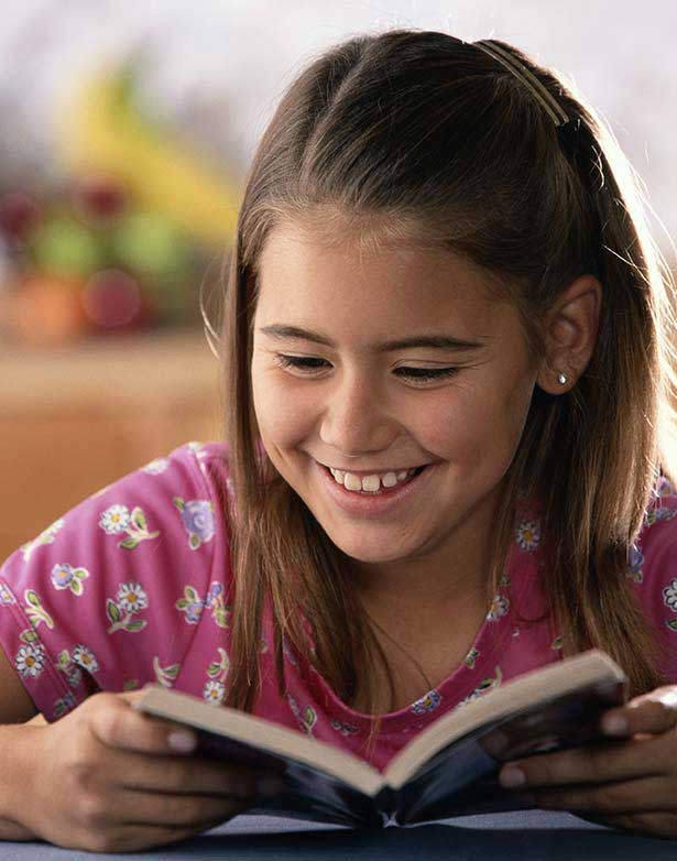 Kid reading a book — Wilmington, NC — Kids & Company