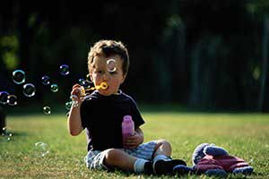 Kid blowing bubbles — Wilmington, NC — Kids & Company