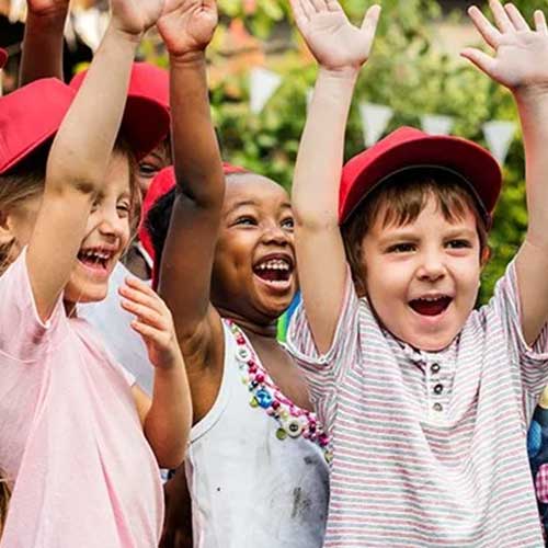 Happy kids raising their hands — Wilmington, NC — Kids & Company