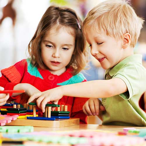 Two kids playing together — Wilmington, NC — Kids & Company