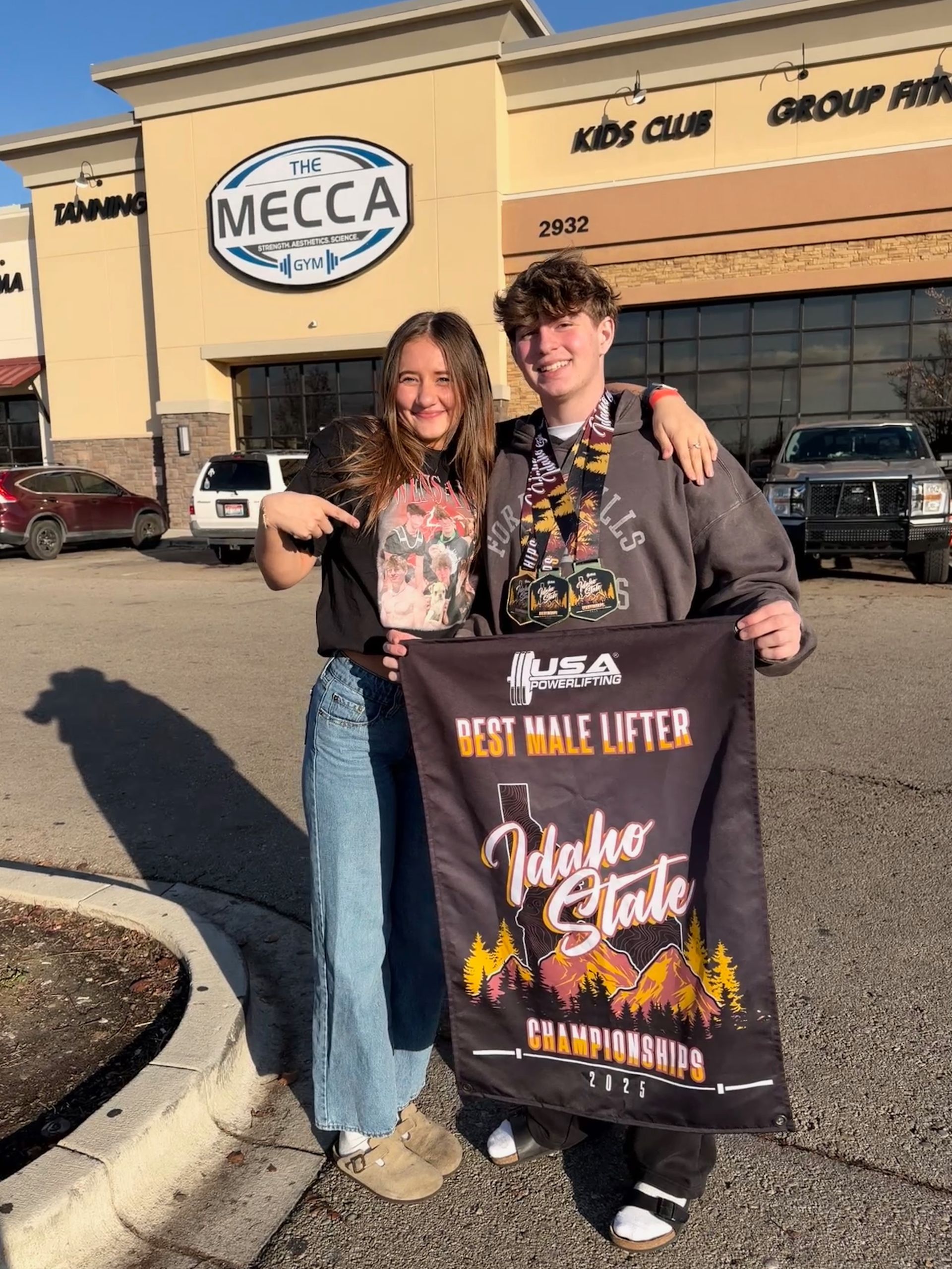 Two smiling people hold a