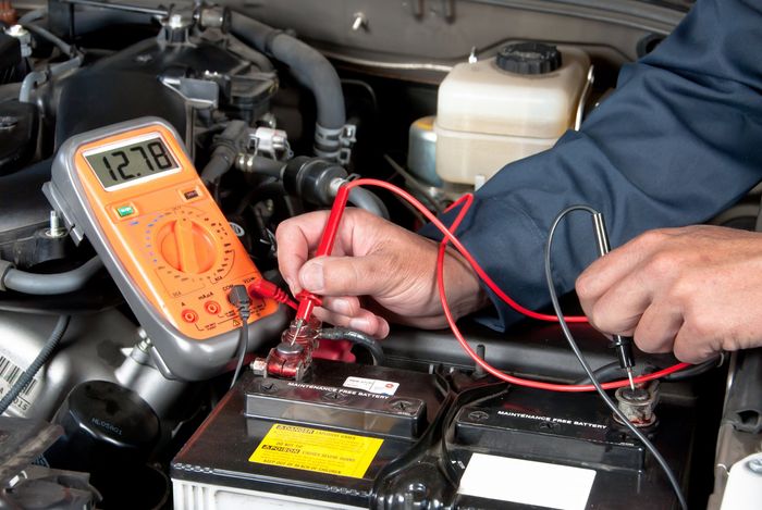 Professional technician checking the car battery — Canton, OH — Northern Mobile Electric