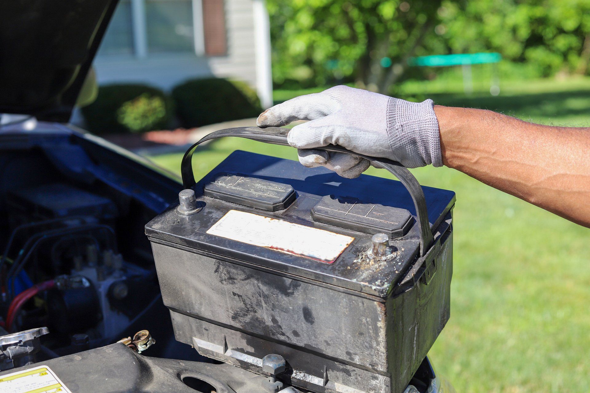 Professional technician holding a car battery — Canton, OH — Northern Mobile Electric