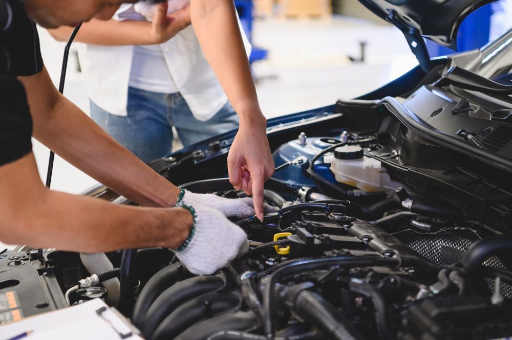 Mechanic Working Under a Car Hood in a Garage — Precision Tuning in Trinity Beach, QLD