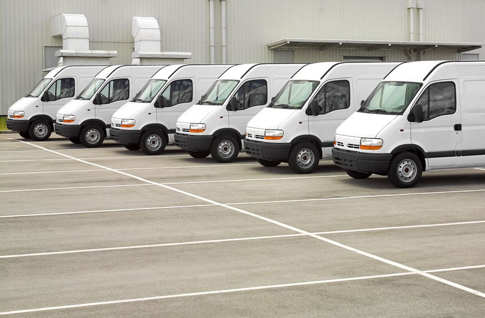 Row of White Delivery Vans Parked in an Empty Lot — Precision Tuning in Redlynch, QLD