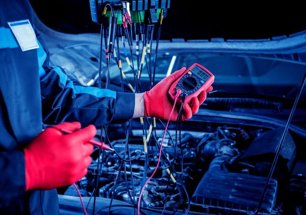 Mechanic Tests Car Electrical System with A Multimeter — Precision Tuning in Bungalow, QLD