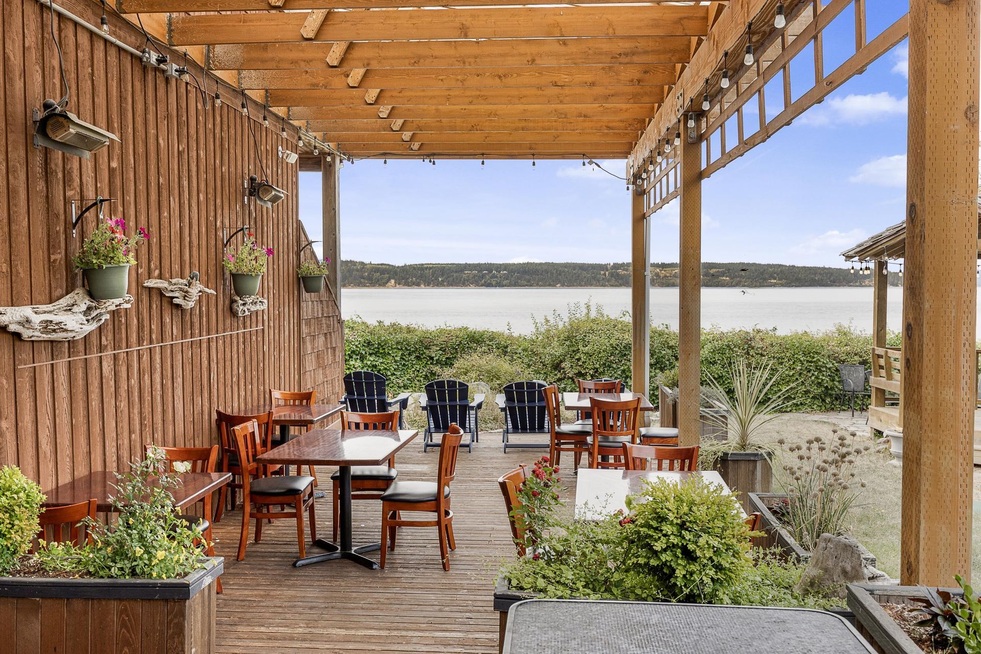 A room with tables and chairs and a fireplace.
