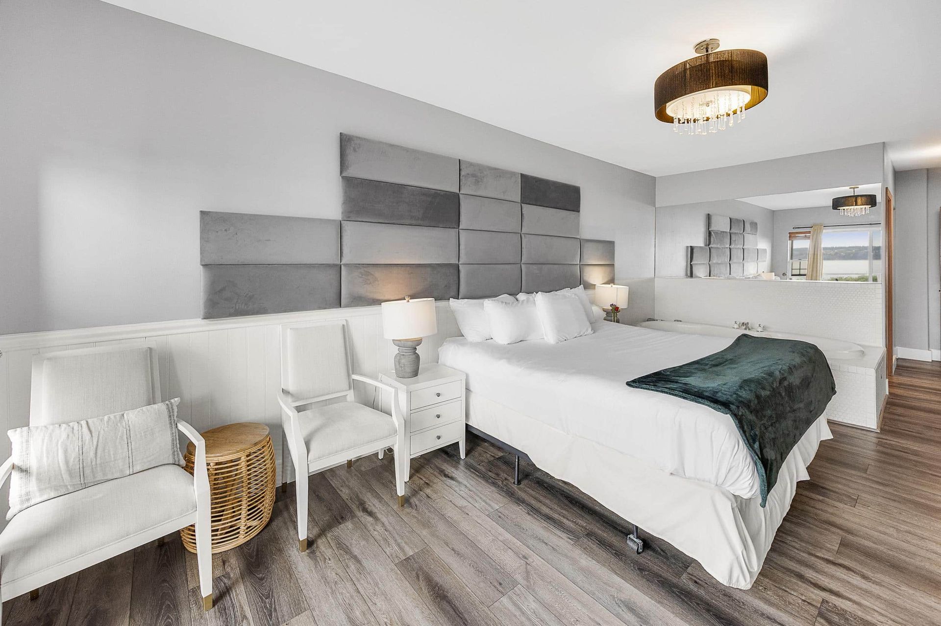 A hotel room with a four poster bed and a bathtub