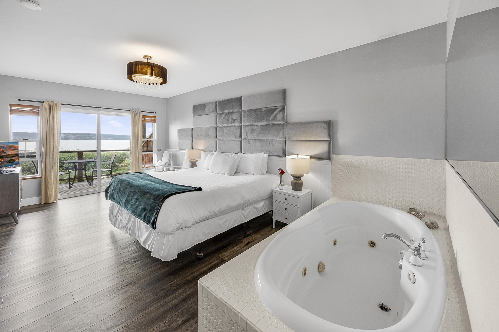 A hotel room with a jacuzzi tub and a bed