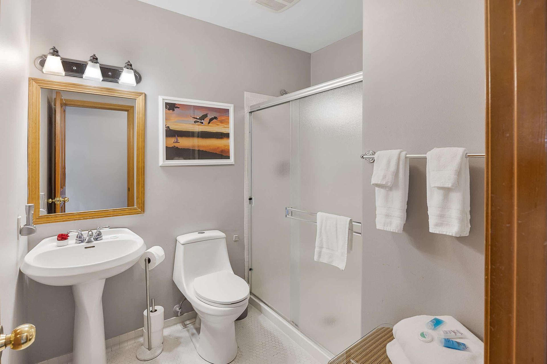 The sun is setting over a lake with a cloudy sky in the background.