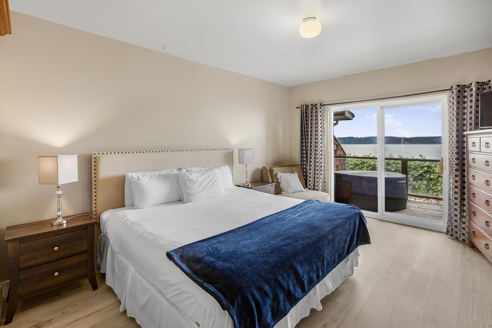 A bedroom with a large bed and a sliding glass door