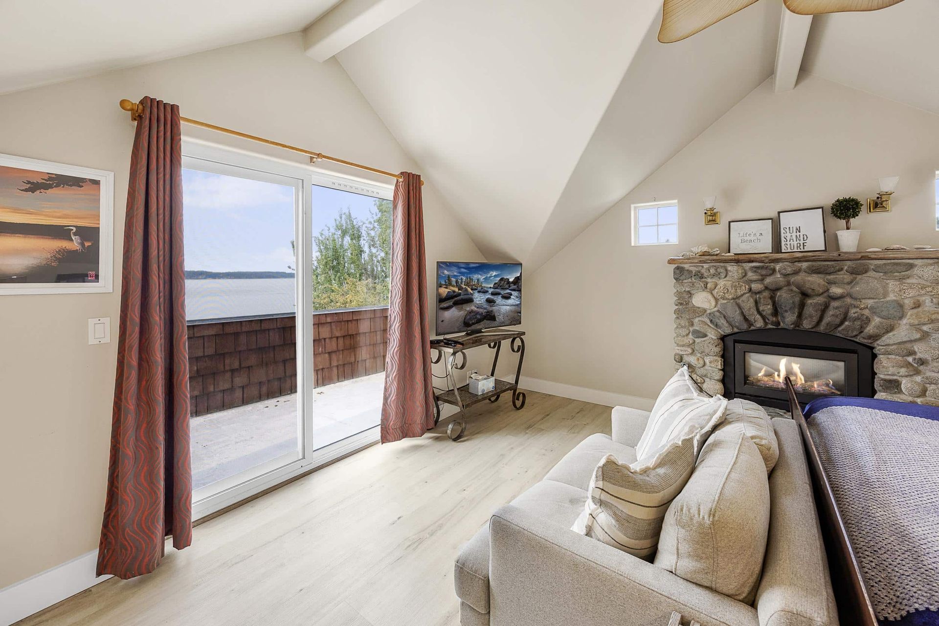 A bedroom with a king size bed and a fireplace