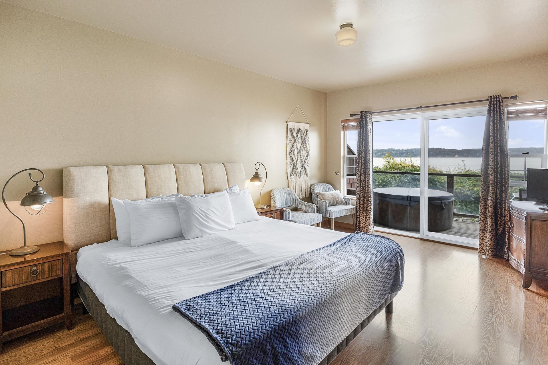 A four poster bed in a hotel room with red walls