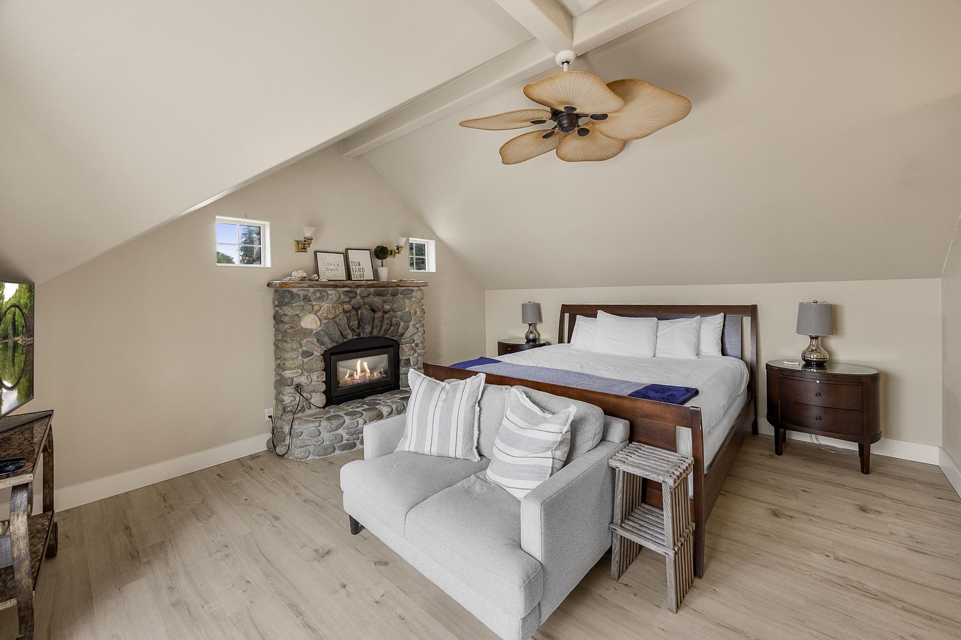 A bedroom with a large bed and a television