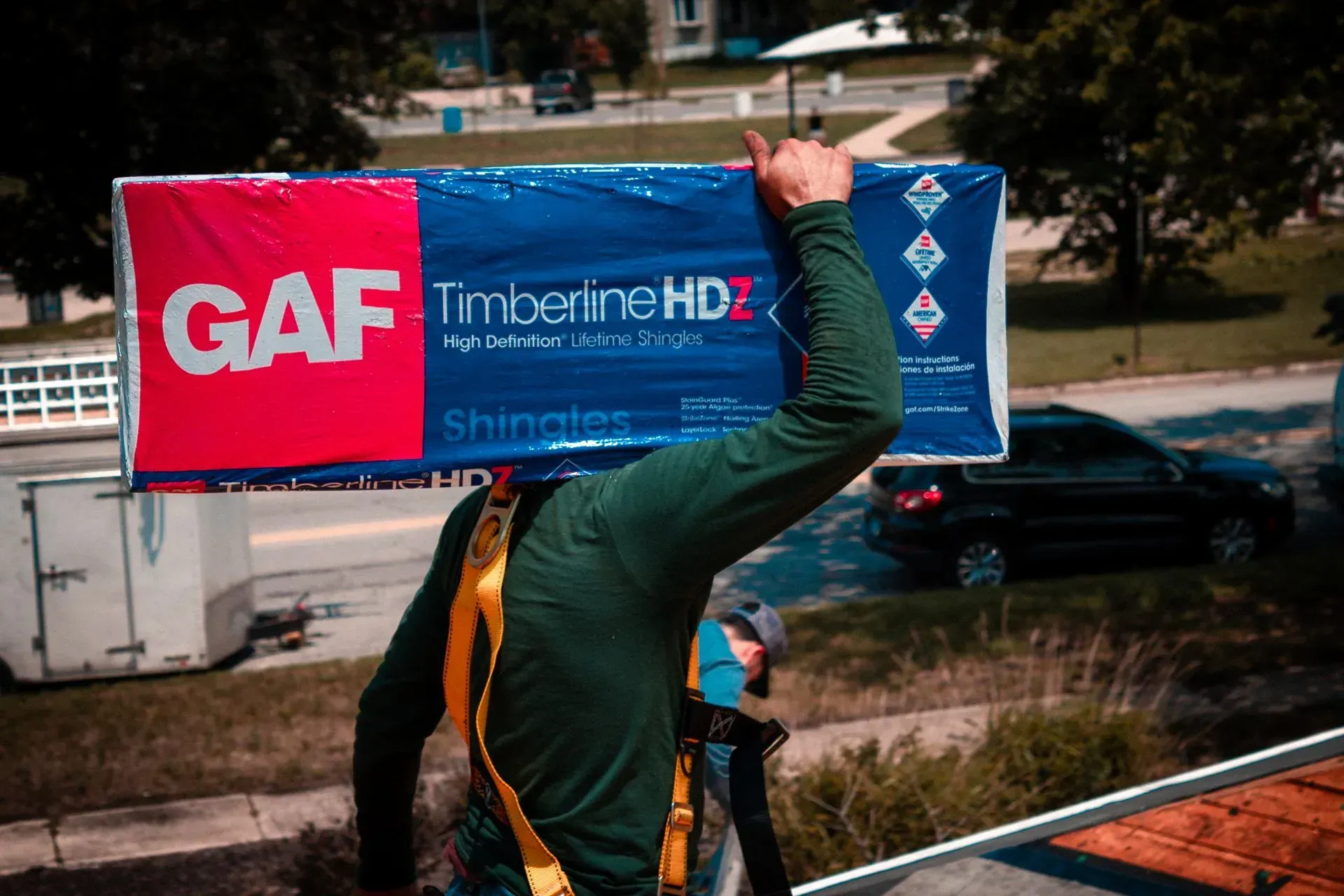 A man is carrying a large box on his head.
