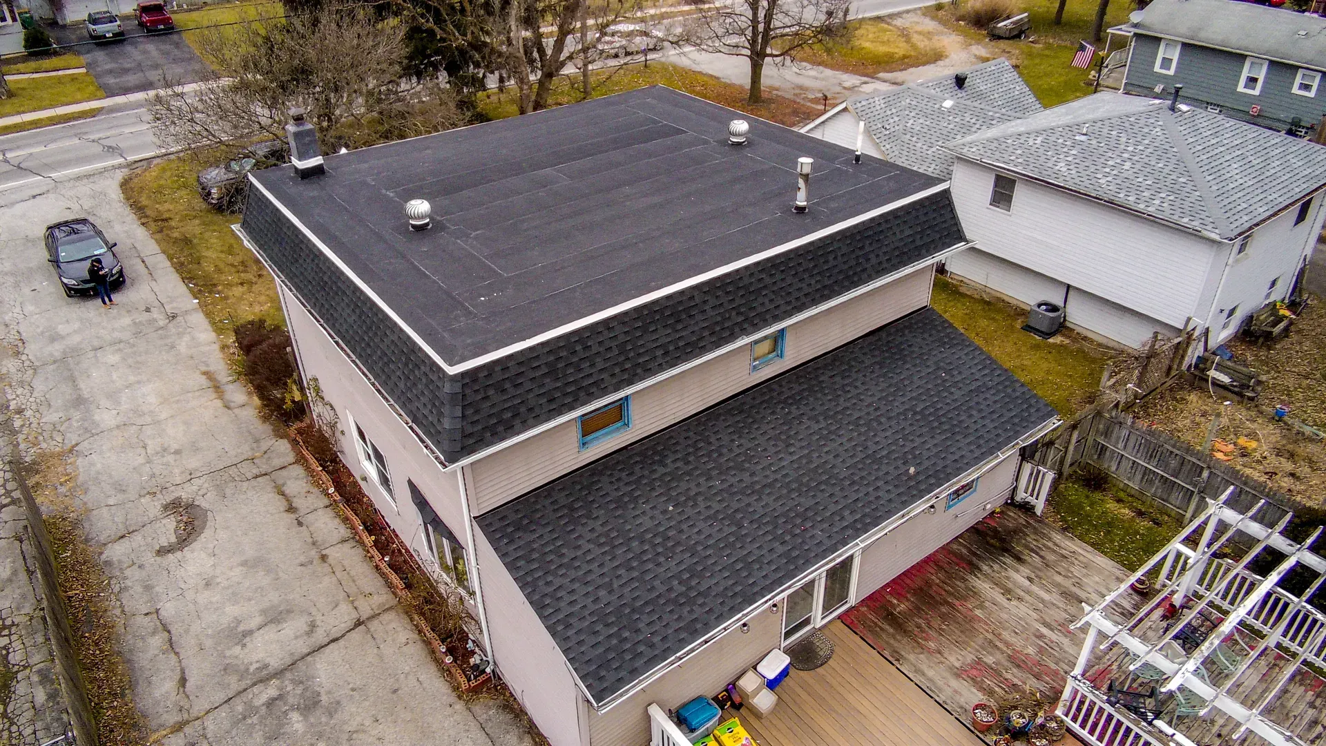 An aerial view of a house with a new roof.