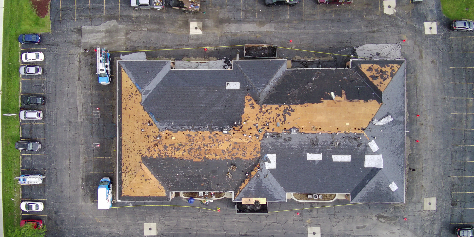 An aerial view of a building under construction in a parking lot.