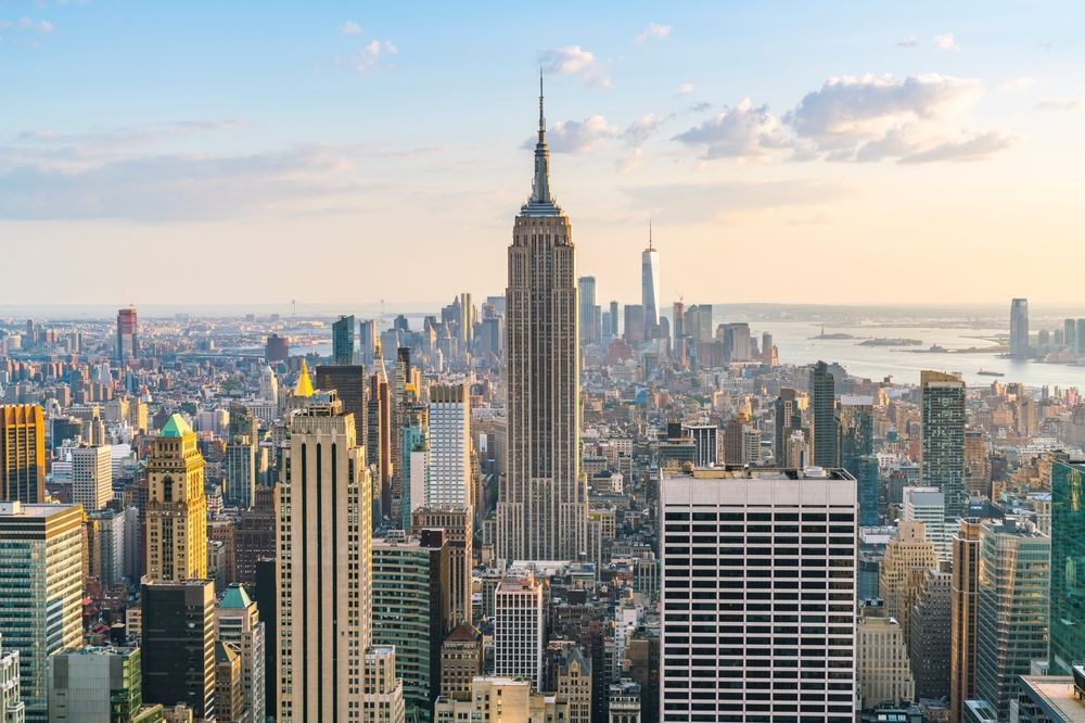 New York City skyline with the Empire State Building centered and the World Trade Center visible.