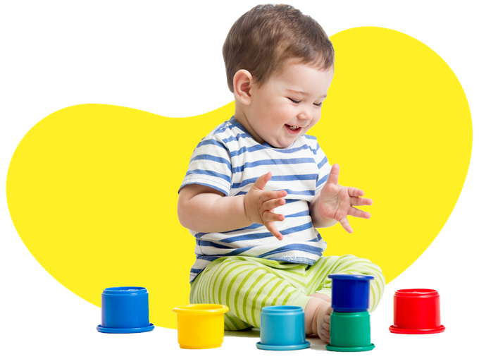 funny baby playing with colourful cup toys on floor