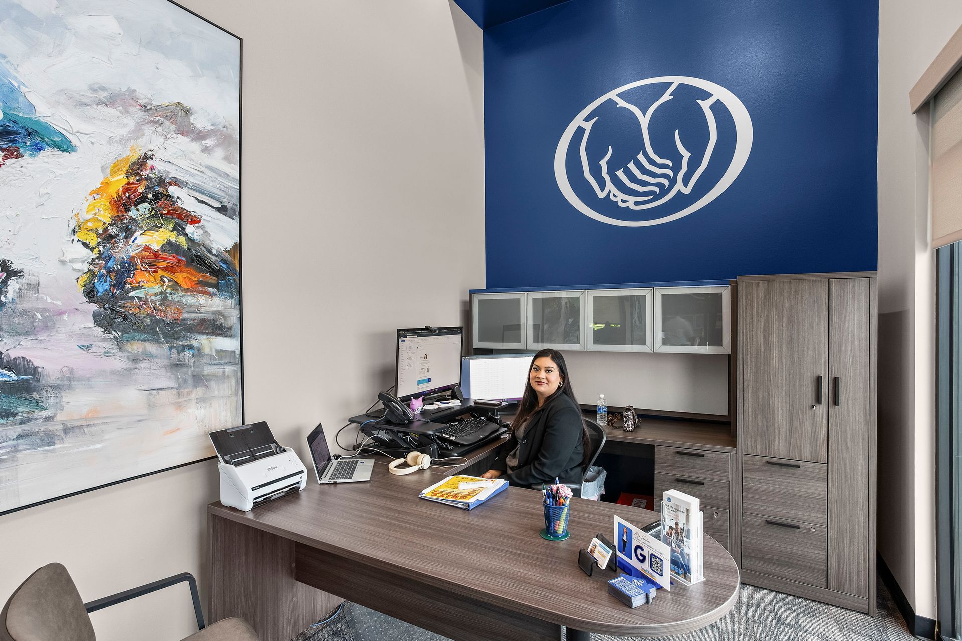 Team member sitting at her office desk.