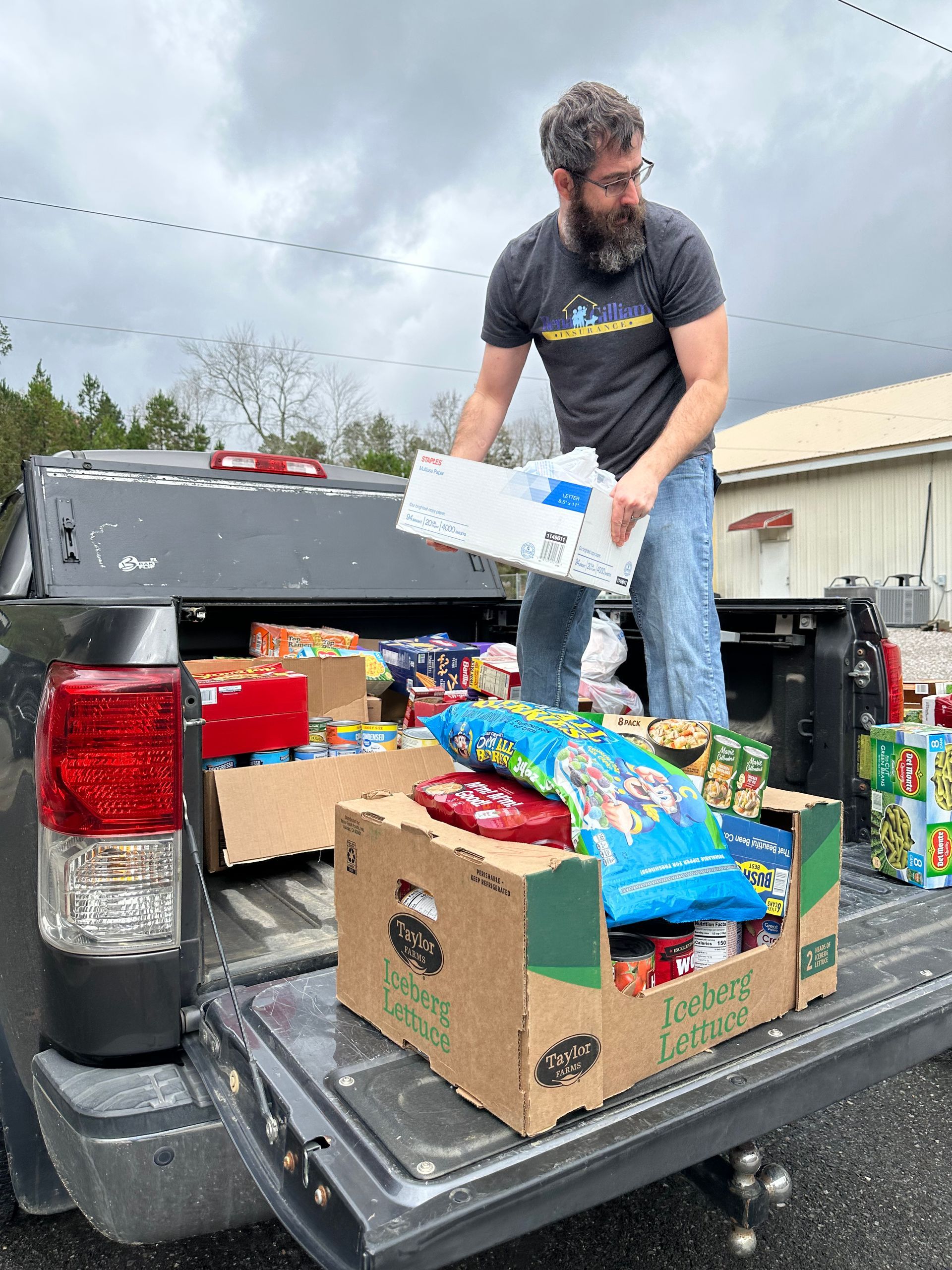 Team member loading food donations onto a truck.