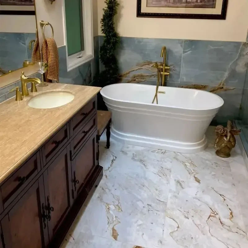 Luxurious bathroom with a freestanding tub, gold fixtures, and marble flooring.