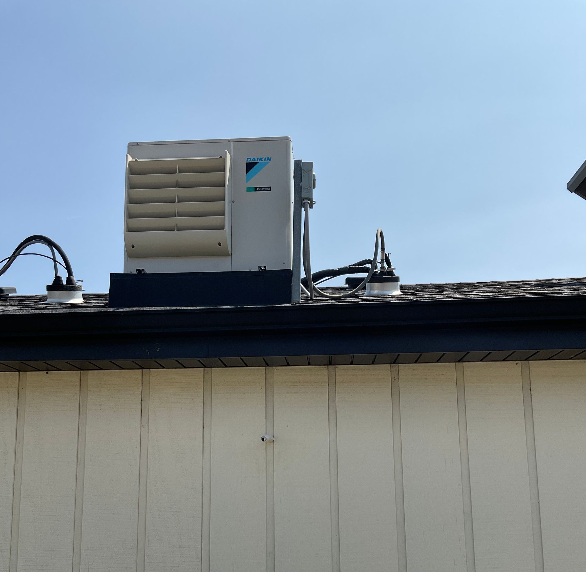 A daikin air conditioner is mounted on the side of a building