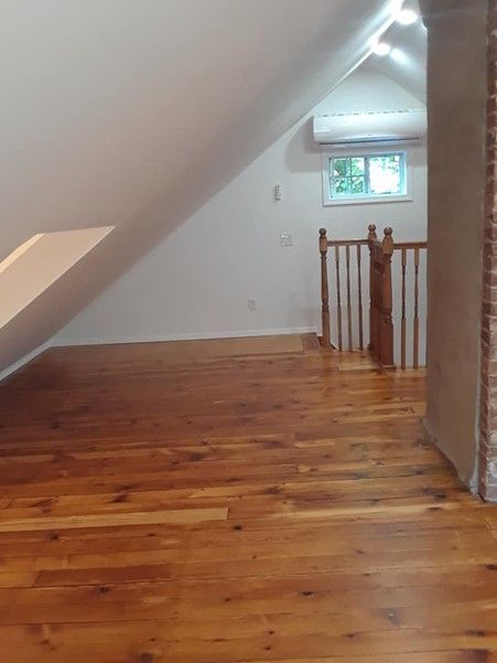 An Empty Room With A Wooden Floor And Stairs — Nyack, NY — FWS Home Improvement
