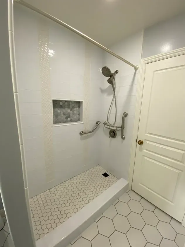 A bathroom with a walk in shower and a door.