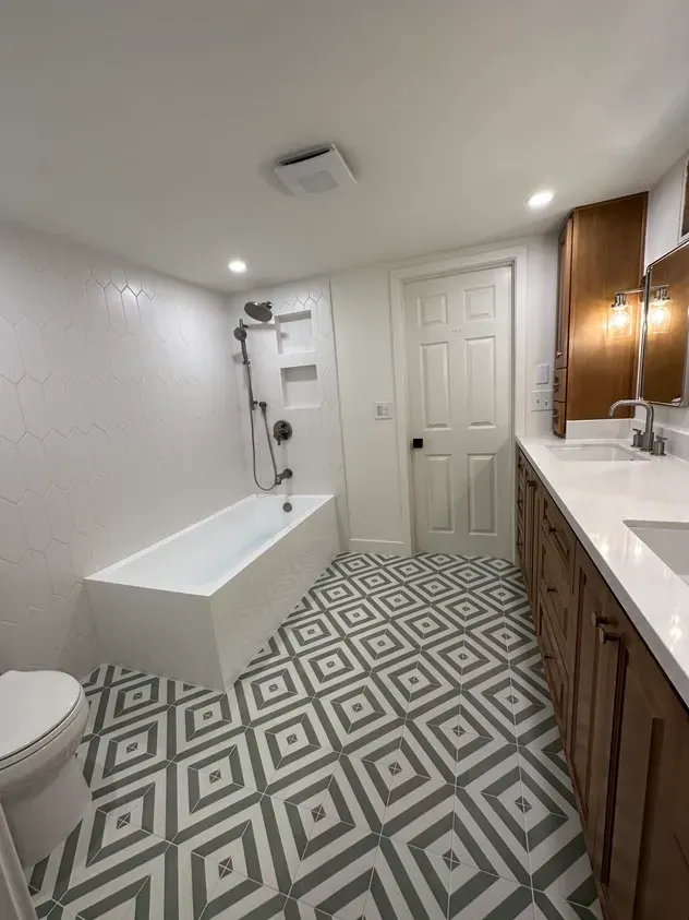 A bathroom with a bathtub, toilet, sink and shower.