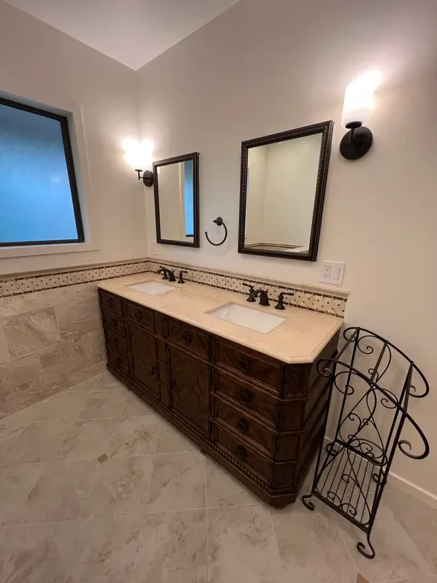 A bathroom with two sinks and two mirrors.