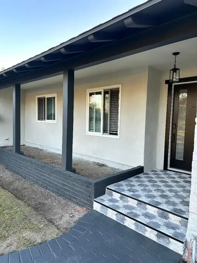 The front of a house with a porch and stairs.