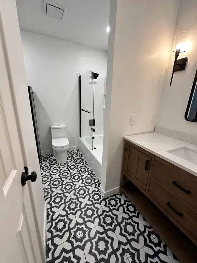 A bathroom with a toilet, sink, and bathtub.