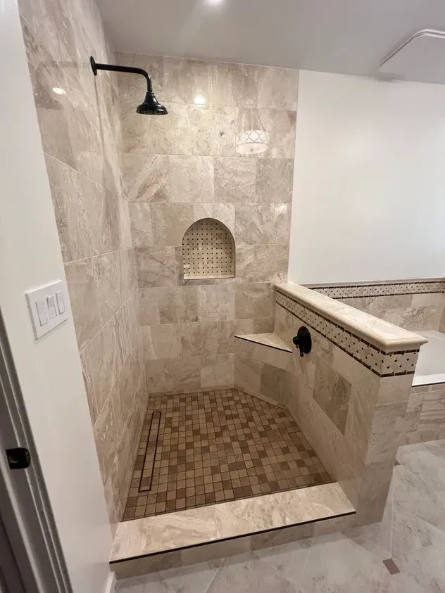 A bathroom with a walk in shower and a tub.