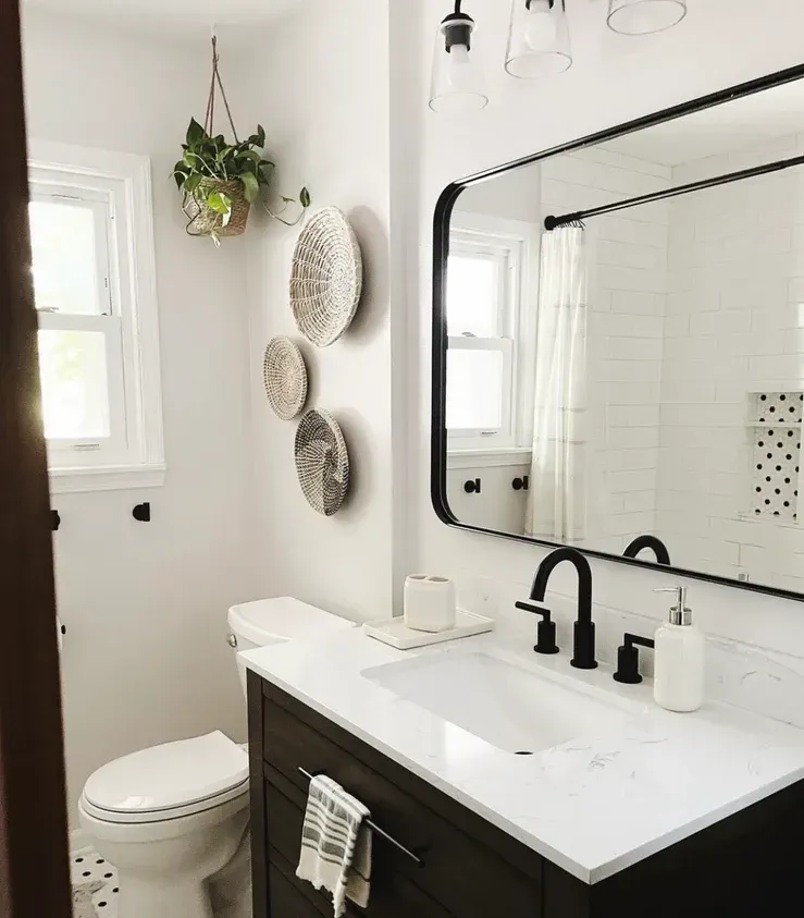 A bathroom with a toilet, sink and mirror