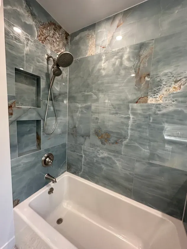 A bathroom with a bathtub and a shower.