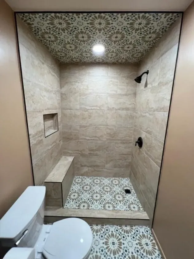 A bathroom with a toilet and a walk in shower.