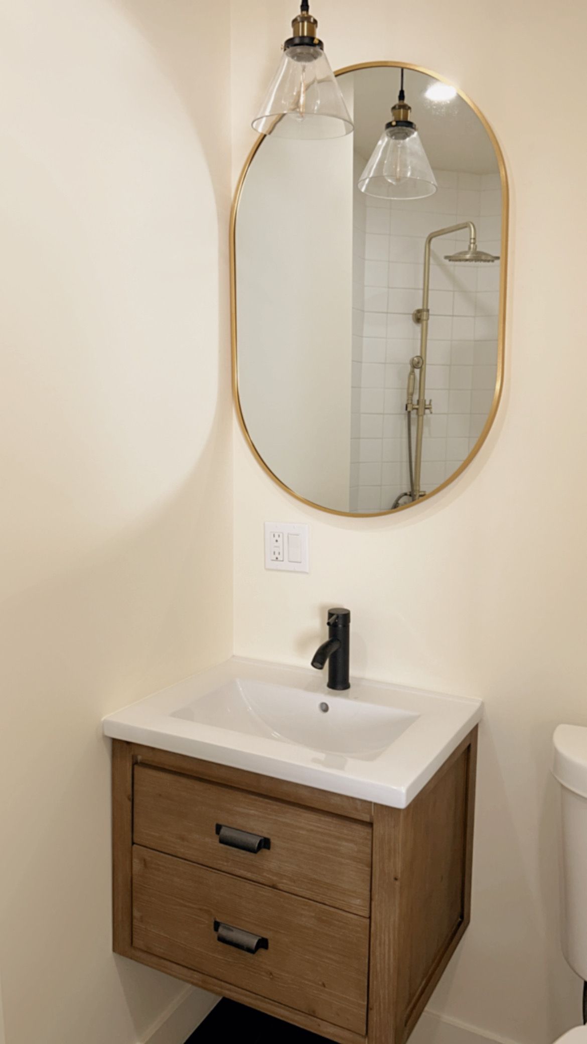 A bathroom with a sink , mirror and toilet.