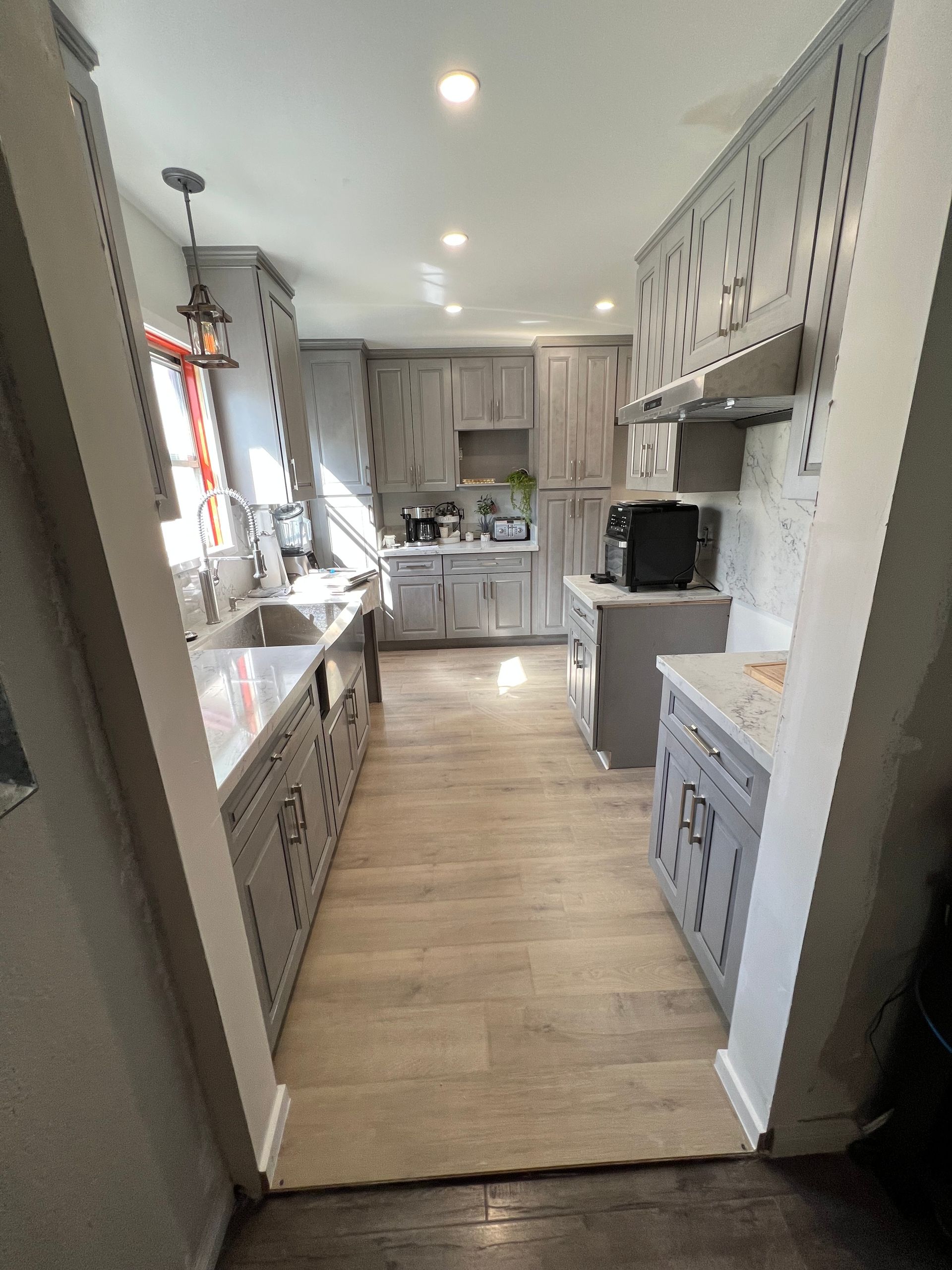 A kitchen with a sink , stove , and microwave.