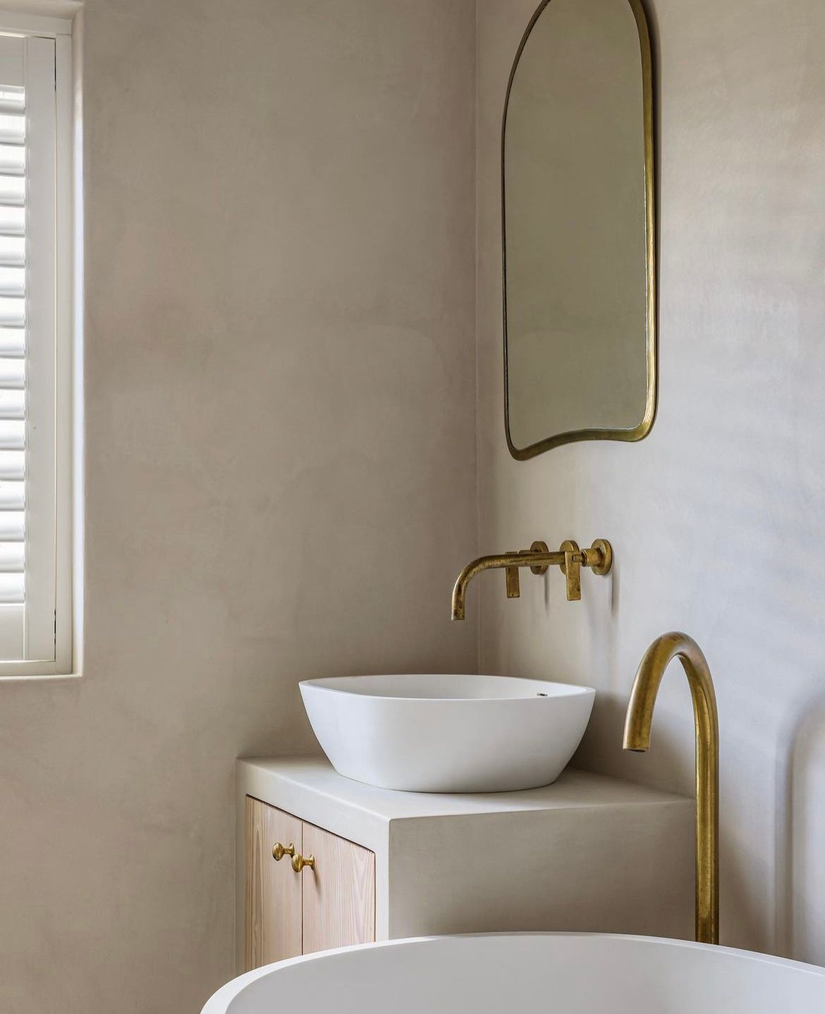 A bathroom with a sink and a mirror on the wall