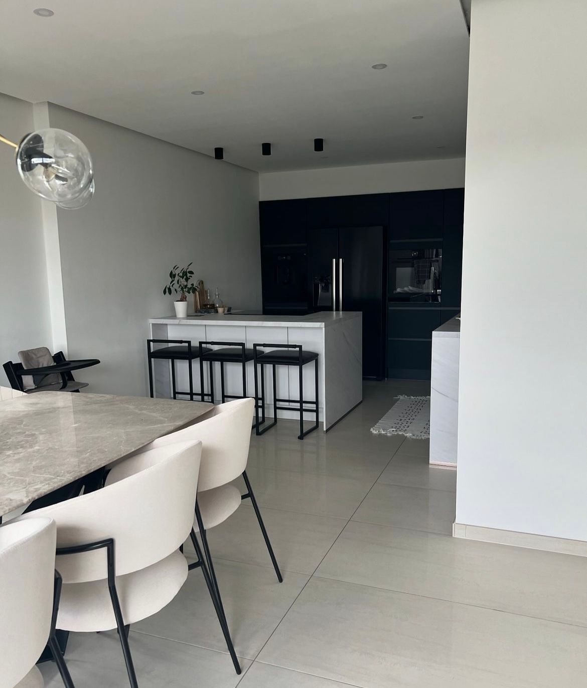 A kitchen with a table and chairs in it