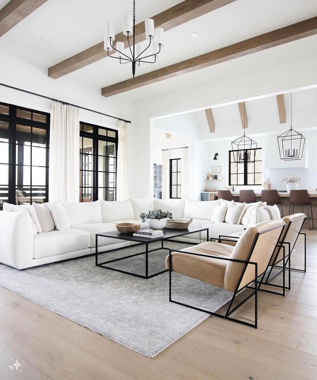 A living room with a couch , chairs , coffee table and rug.