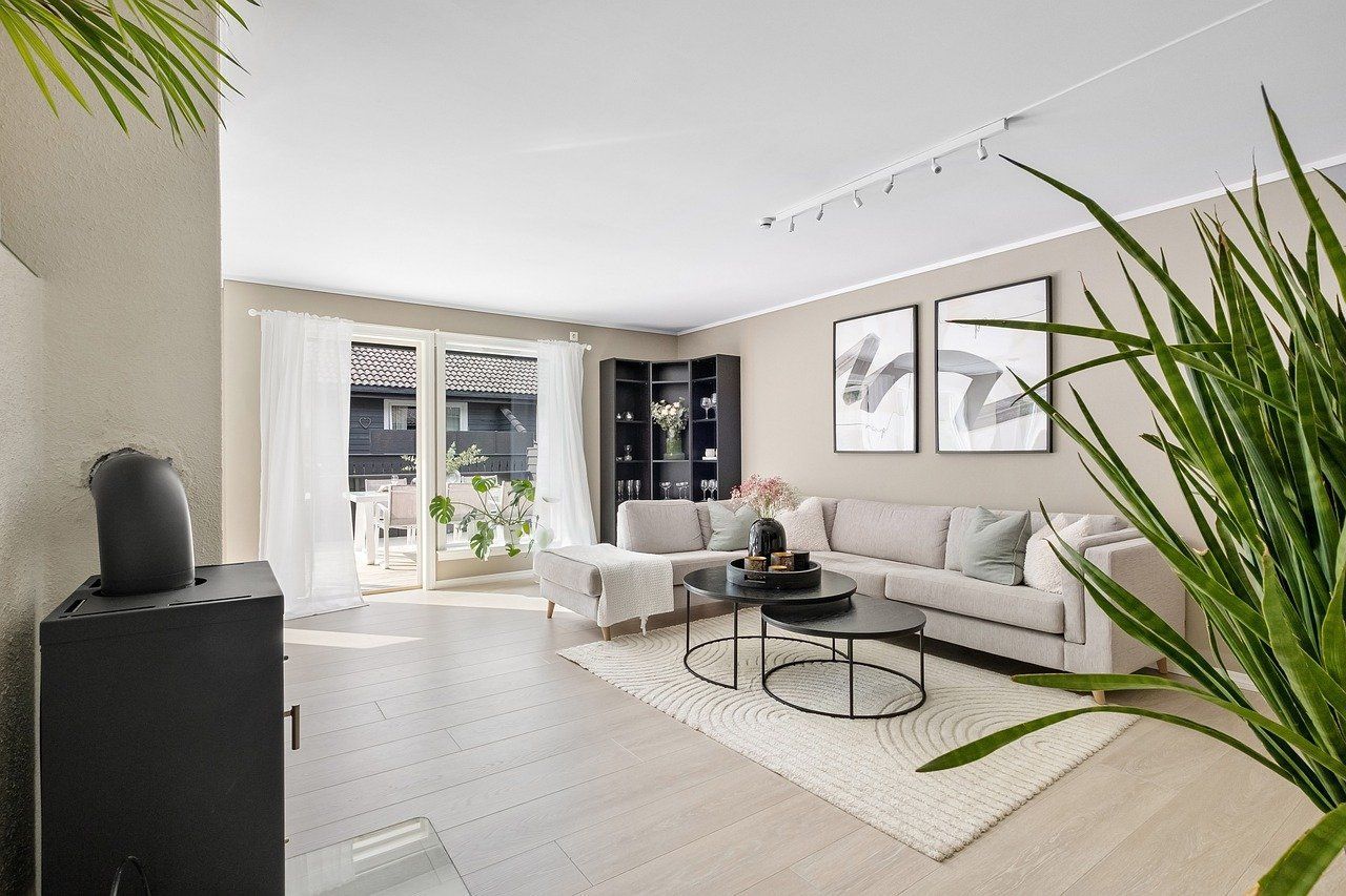 A living room with a couch, coffee table, and fireplace.